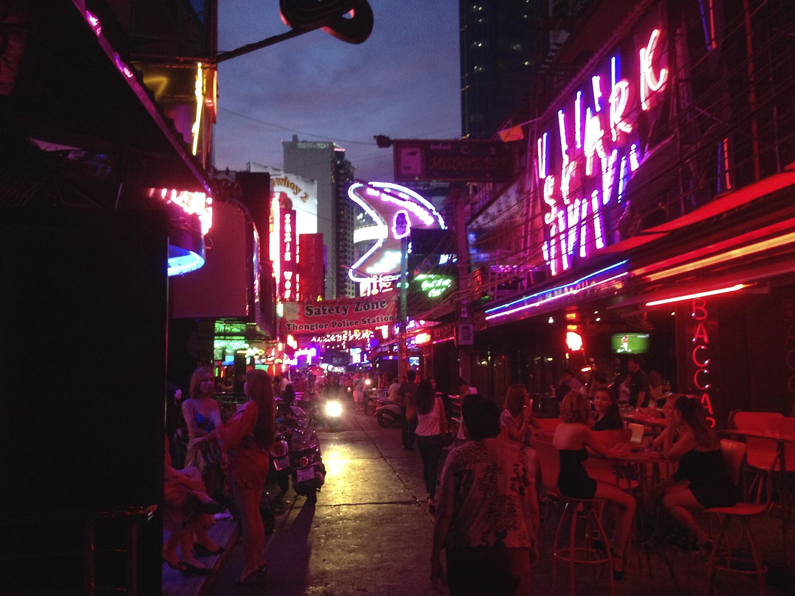 Neon-lit street scene in Bangkok at night
