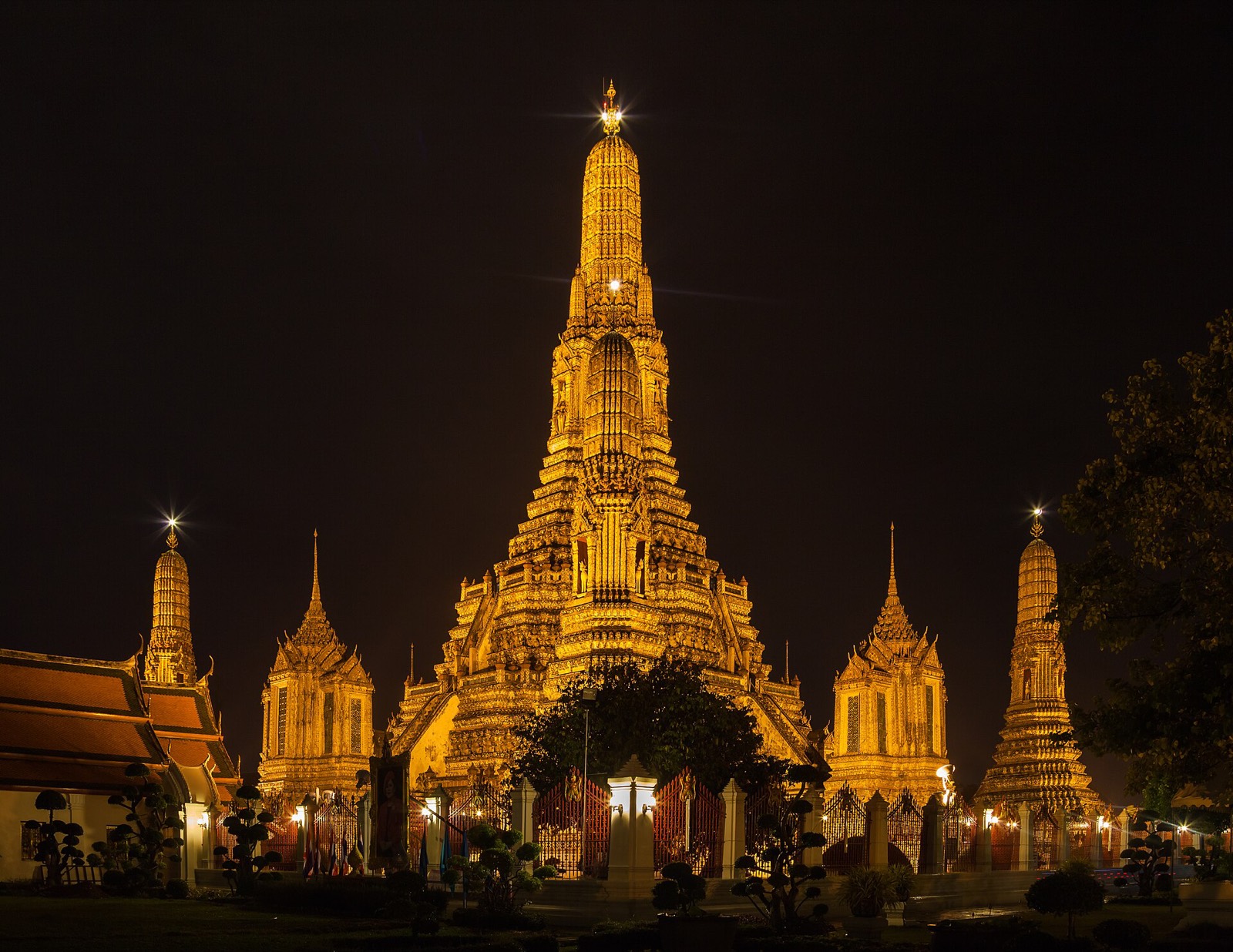 Wat Arun lit gold against the night sky, Bangkok